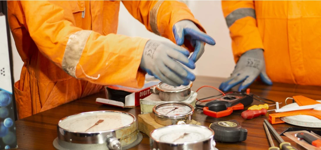 Nuerich technical personnel checking pressure gauges and electrical test instruments